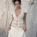 Amélie · Top peplum de encaje translúcido con escote pronunciado