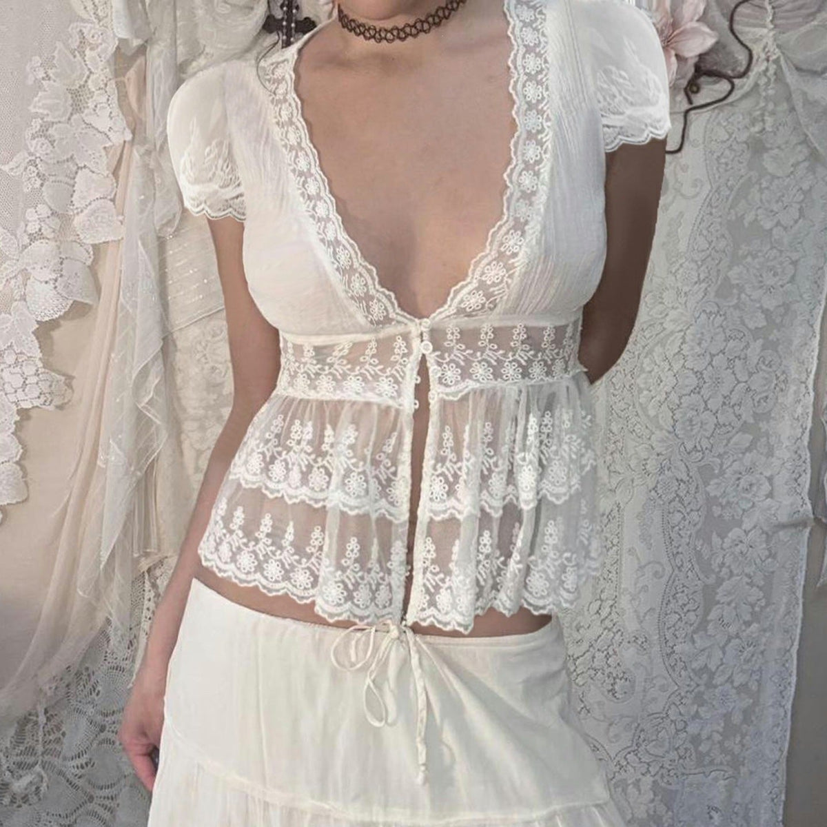 Amélie · Top peplum de encaje translúcido con escote pronunciado