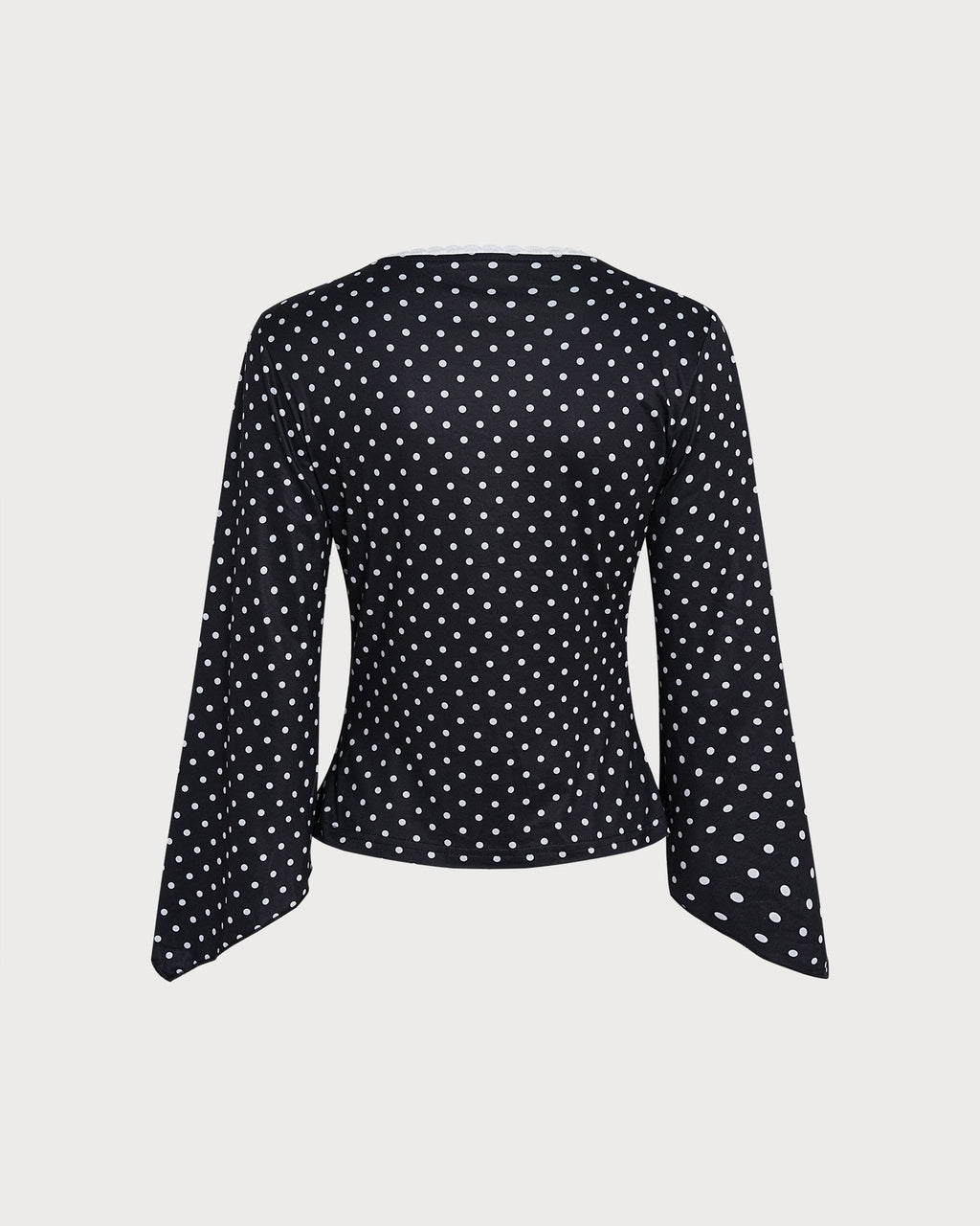 Camiseta de punto negra de lunares con escote en V